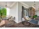 Cozy covered porch featuring comfortable seating, a stylish hanging chair, and views of the landscaped surroundings at 808 Wimberly Rd, Apex, NC 27523
