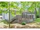 View of the backyard featuring a raised back deck with stairs, a patio door, and an enclosed lattice surround at 81 Honeysuckle Dr, Pittsboro, NC 27312