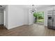 Dining area with modern light fixture, stainless steel refrigerator, and access to backyard at 81 Honeysuckle Dr, Pittsboro, NC 27312