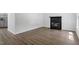 Open-concept living room with modern wood floors and fireplace at 81 Honeysuckle Dr, Pittsboro, NC 27312