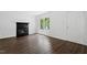 Bright living room with a fireplace, wood flooring and a large window at 81 Honeysuckle Dr, Pittsboro, NC 27312