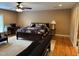 Main bedroom featuring mixed flooring types, neutral walls, and a ceiling fan at 84 Macbeth Ln, Roxboro, NC 27574