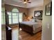 Tranquil bedroom with hardwood floors, a large window, and a comfortable queen-sized bed at 84 Macbeth Ln, Roxboro, NC 27574