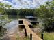 A wooden dock extending into the lake provides access to the water and offers a peaceful retreat at 84 Macbeth Ln, Roxboro, NC 27574