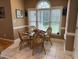 Cozy breakfast nook featuring a glass-top table, wicker chairs, and a large window for natural light at 84 Macbeth Ln, Roxboro, NC 27574