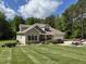 Beautifully landscaped yard complements this tan two-story house, complete with an attached garage and lush greenery at 84 Macbeth Ln, Roxboro, NC 27574
