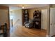 Open hallway area with hardwood floors, view of the staircase, and a reading nook at 84 Macbeth Ln, Roxboro, NC 27574