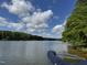 Scenic lake view with clear skies, lush trees, and calm water, creating a serene and inviting atmosphere at 84 Macbeth Ln, Roxboro, NC 27574