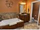 Relaxing main bathroom with a large tub, tiled accents, and elegant vanity area at 84 Macbeth Ln, Roxboro, NC 27574