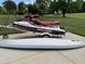 Personal watercraft on a trailer with additional watercraft on the concrete, ready for summer fun at 84 Macbeth Ln, Roxboro, NC 27574