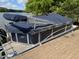 Covered pontoon boat docked, offering a convenient and protected spot to enjoy water activities at 84 Macbeth Ln, Roxboro, NC 27574