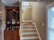 Bright staircase with hardwood steps, white risers and banister, and nearby built-in shelving unit at 84 Macbeth Ln, Roxboro, NC 27574