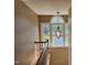 Staircase with hardwood steps, white banister, and transom window overlooking the backyard at 84 Macbeth Ln, Roxboro, NC 27574