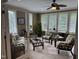 Bright sunroom with lots of windows providing ample light, tiled floors, and comfortable furnishings for relaxing at 84 Macbeth Ln, Roxboro, NC 27574