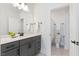 This bathroom features a gray vanity with black hardware, a white countertop and a framed mirror above the sink at 8416 Brady Pointe Rd, Fuquay Varina, NC 27526