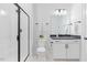 Modern bathroom featuring a sleek glass-enclosed shower, white vanity, and stylish fixtures at 8416 Brady Pointe Rd, Fuquay Varina, NC 27526