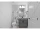Well-lit bathroom featuring a sleek vanity, toilet, and wall mirror at 8416 Brady Pointe Rd, Fuquay Varina, NC 27526