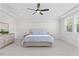This bedroom boasts ample natural light, soft neutral paint and carpet and a modern ceiling fan at 8416 Brady Pointe Rd, Fuquay Varina, NC 27526