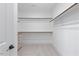 This walk-in closet has wall to wall shelving and a dresser with soft carpet at 8416 Brady Pointe Rd, Fuquay Varina, NC 27526