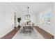 Bright dining room with modern chandelier, wainscoting, and large windows at 8416 Brady Pointe Rd, Fuquay Varina, NC 27526