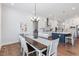 Open-concept dining room connected to a modern kitchen featuring a stylish chandelier at 8416 Brady Pointe Rd, Fuquay Varina, NC 27526