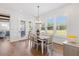Sunlit dining room with hardwood floors and access to the backyard patio at 8416 Brady Pointe Rd, Fuquay Varina, NC 27526