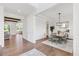 Open-concept dining area with modern lighting, wainscoting, and hardwood floors at 8416 Brady Pointe Rd, Fuquay Varina, NC 27526