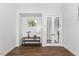 Elegant entryway with console table, decorative lamp, and double glass doors leading to other rooms at 8416 Brady Pointe Rd, Fuquay Varina, NC 27526