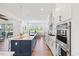 Bright kitchen with stainless steel appliances, an oversized island, and hardwood floors at 8416 Brady Pointe Rd, Fuquay Varina, NC 27526