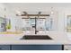 Open concept kitchen with an island sink, view to the living room, and stainless steel appliances at 8416 Brady Pointe Rd, Fuquay Varina, NC 27526