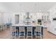 Bright kitchen with a large island, pendant lights, and stainless steel appliances with hardwood floors at 8416 Brady Pointe Rd, Fuquay Varina, NC 27526