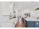 Beautiful kitchen featuring white cabinets, stainless steel appliances, an island, and hardwood floors at 8416 Brady Pointe Rd, Fuquay Varina, NC 27526