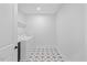 This laundry room features mosaic tile floors, white walls and a washer and dryer at 8416 Brady Pointe Rd, Fuquay Varina, NC 27526