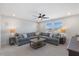 Cozy living room featuring a large sectional sofa, and windows providing natural light at 8416 Brady Pointe Rd, Fuquay Varina, NC 27526