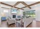 Cozy living room with exposed wood beams, a brick fireplace, and access to an outdoor space at 8416 Brady Pointe Rd, Fuquay Varina, NC 27526