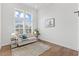 Bright living room boasts large windows, hardwood floors, and neutral decor for a welcoming atmosphere at 8416 Brady Pointe Rd, Fuquay Varina, NC 27526