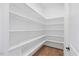 Walk-in pantry with multiple shelves and hardwood floors at 8416 Brady Pointe Rd, Fuquay Varina, NC 27526