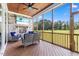 Inviting screened porch with stone fireplace, comfortable seating, and views of the backyard at 8416 Brady Pointe Rd, Fuquay Varina, NC 27526