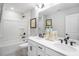 Bathroom with double sink vanity, bathtub and shower, plus modern fixtures at 8728 Wardle Ct, Wake Forest, NC 27587