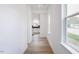 Bright hallway with wood flooring, offering seamless transition into a modern kitchen at 8728 Wardle Ct, Wake Forest, NC 27587