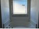 Bathroom with a tub and a large window at 91 Retreat Run, Smithfield, NC 27577