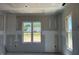 Bright living room space featuring large windows and neutral wall colors, ready for finishing touches at 91 Retreat Run, Smithfield, NC 27577