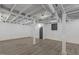 Finished basement with vinyl flooring and open ceiling with duct work visible at 1012 Rainey St, Burlington, NC 27217