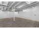 Finished basement offers an open ceiling, vinyl flooring and painted white walls at 1012 Rainey St, Burlington, NC 27217