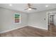 Spacious bedroom showcasing hardwood floors, multiple windows, and fresh paint at 1012 Rainey St, Burlington, NC 27217