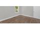 Bright bedroom featuring wood floors, a window for natural light, and neutral paint at 1012 Rainey St, Burlington, NC 27217