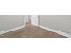 Bedroom with gray walls, white trim, a door, and wood-look floors at 1012 Rainey St, Burlington, NC 27217