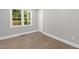 Well-lit bedroom with wood floors, gray walls, a window and white trim at 1012 Rainey St, Burlington, NC 27217