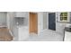 Remodeled kitchen with gray backsplash, modern appliances, and marble floors at 1012 Rainey St, Burlington, NC 27217