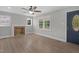 Bright living room with hardwood floors, a fireplace, and natural light from large windows at 1012 Rainey St, Burlington, NC 27217